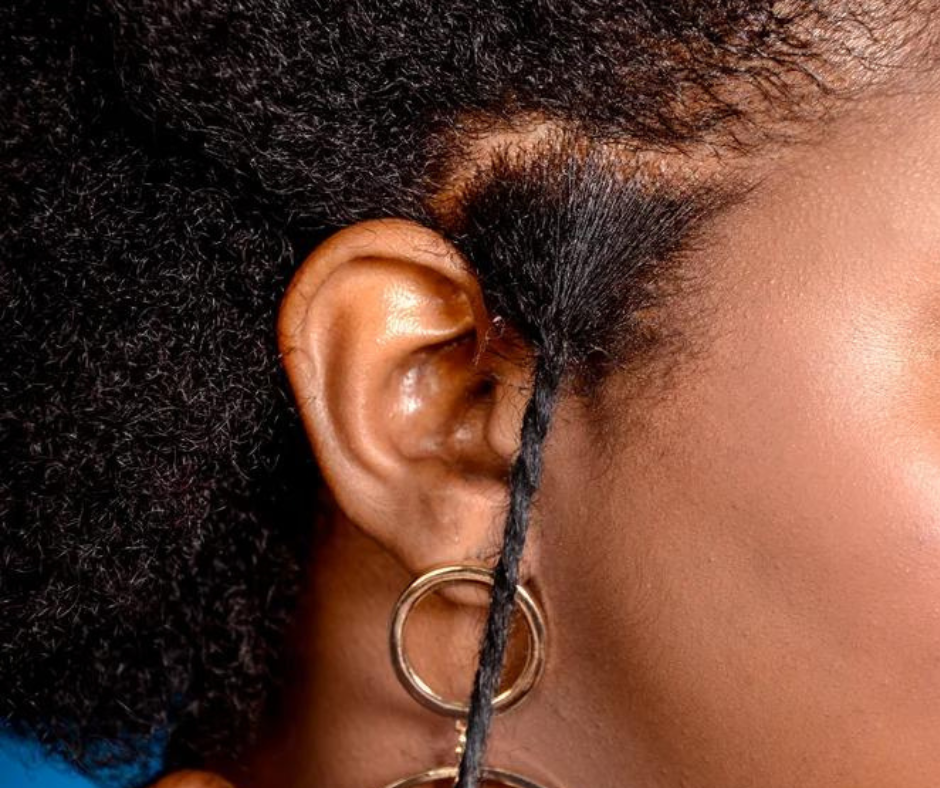 Image of a model stretching her curly hair