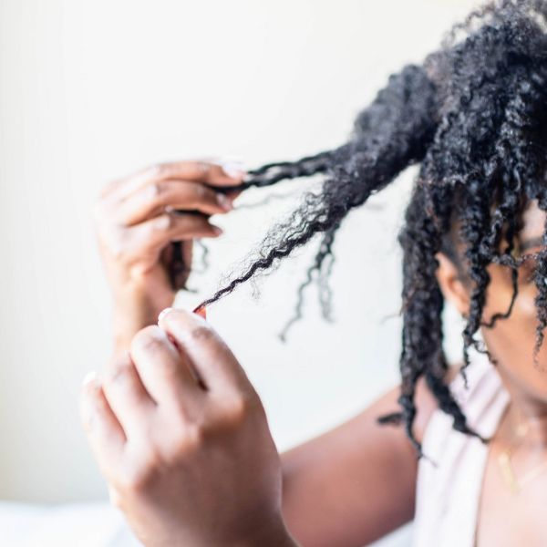 Picture of a woman holding her dry hair 