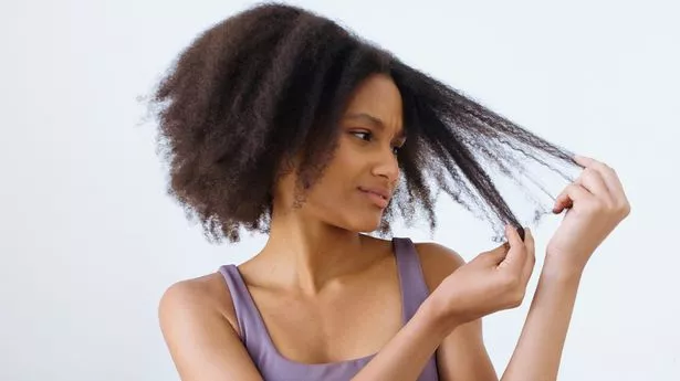 Image of a-beautiful-black-girl-with-curly-tangled-unruly-hair-worried-about-her-damaged-tips