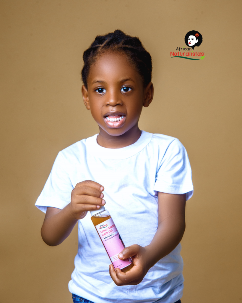 A child holding African Naturalistas Hair Growth Oil with a neat braid