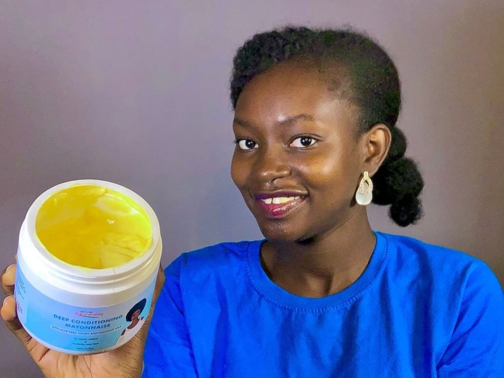 African Naturalistas Model Holding the Deep Conditioning Mayonnaise