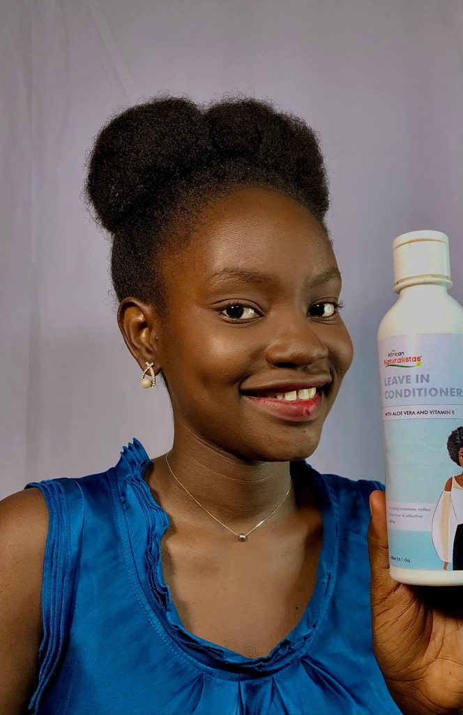 African Naturalistas model holding the leave-in conditioner